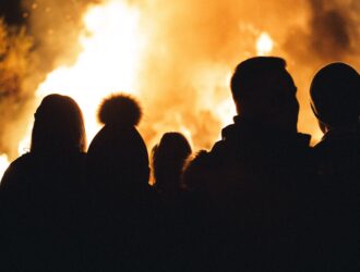 Crowd of people around a bonfire
